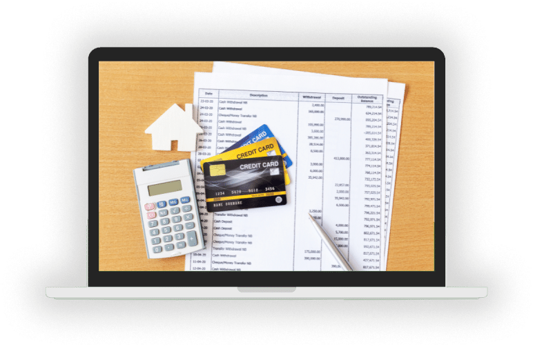 A computer showing a credit card processing statement, cards, and a calculator